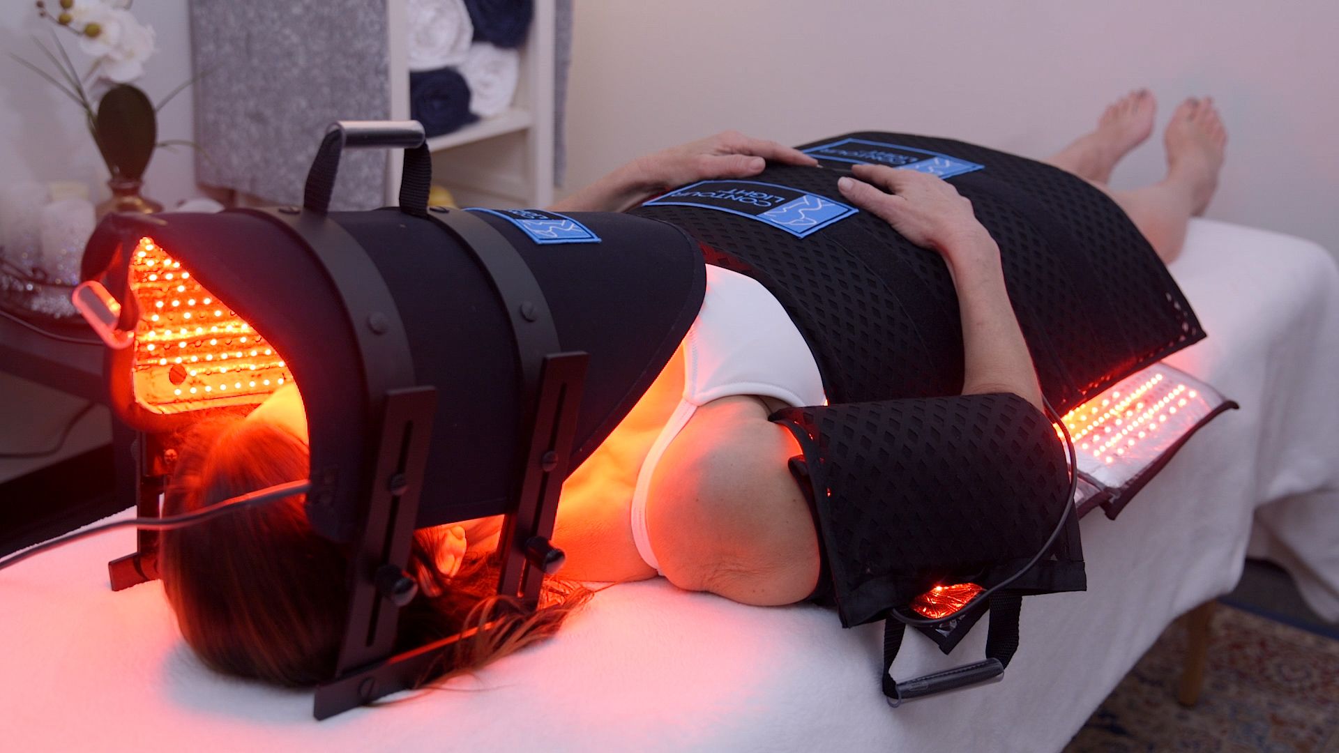 woman in red light therapy device