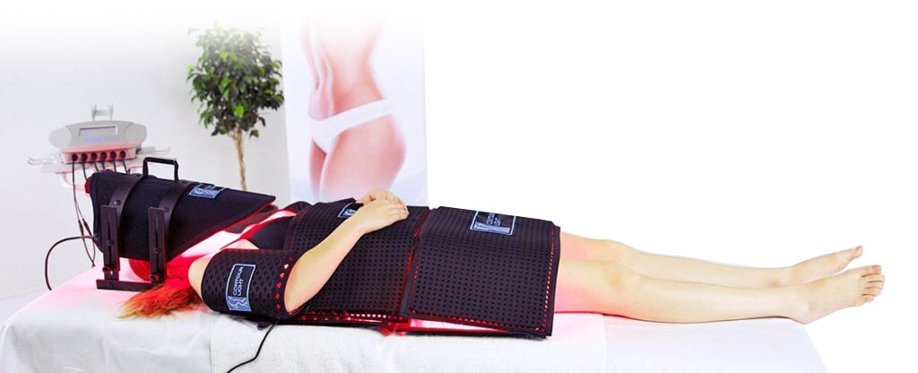 A patient lying comfortably on a treatment table with the full body Contour Light professional red light therapy machine