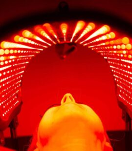Administering red light therapy for skin rejuvenation with a special contoured mask.