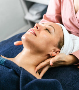 a wellness practitioner performing massage on a client, how to start a red light therapy business