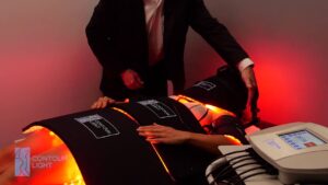 a practitioner demonstrating the safety of the full body Contour Light therapy system in use on a patient